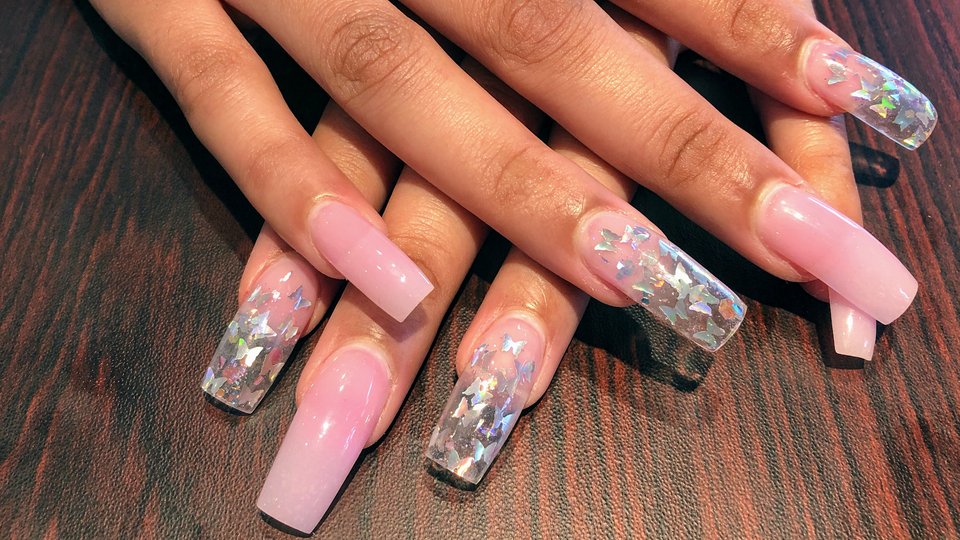 Nail salon station with manicure tools and polish bottles.