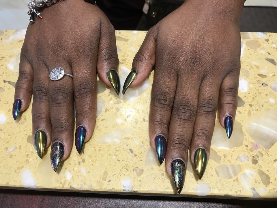 Nail salon station with manicure tools and polish bottles.